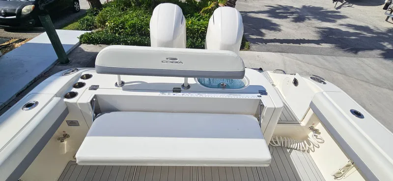 Slide: The Image of 2019 Cobia 280 Center Console boat with dual engines and seating area. - 8