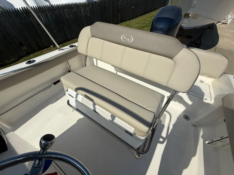 Slide: The Image of 2021 Key West 189 FS boat seat with beige upholstery and stainless steel frame. - 11