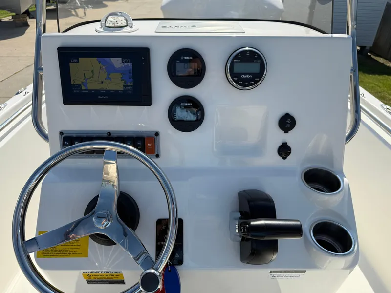 Slide: The Image of 2021 Key West 189 FS boat dashboard with steering wheel, gauges, and navigation display. - 12