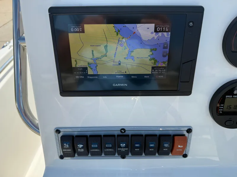Slide: The Image of Garmin navigation display on 2021 Key West 189 FS boat dashboard with control switches. - 13