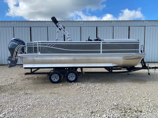 Slide: The Image of 2025 SunCatcher Select 322RF pontoon boat on trailer, parked outdoors. - 0
