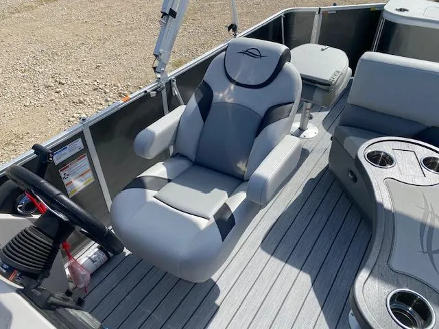 Slide: The Image of 2025 SunCatcher Select 322RF boat interior with plush seating and modern steering console. - 12