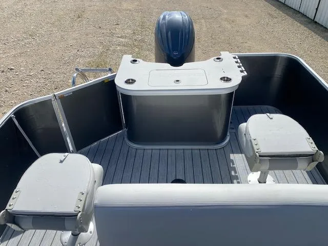 Slide: The Image of 2025 SunCatcher Select 322RF boat interior with seating and motor, viewed from above. - 14