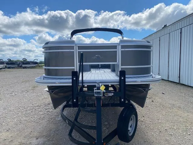 Slide: The Image of 2025 SunCatcher Select 322RF pontoon boat on trailer, parked outdoors under cloudy sky. - 2