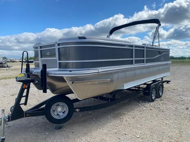 Slide: The Image of 2025 SunCatcher Select 322RF pontoon boat on trailer under a partly cloudy sky. - 3