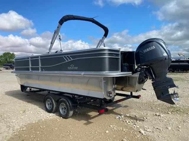 Slide: The Image of 2025 SunCatcher Select 322RF pontoon boat with Yamaha engine on a trailer. - 4