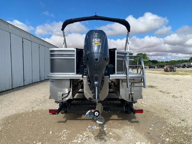 Slide: The Image of 2025 SunCatcher Select 322RF pontoon boat with 150 HP engine, parked outdoors. - 5