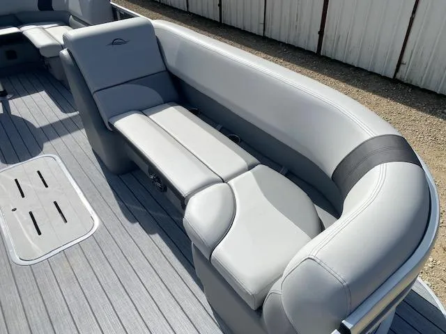 Slide: The Image of 2025 SunCatcher Select 322RF boat interior with sleek gray seating and modern design. - 9