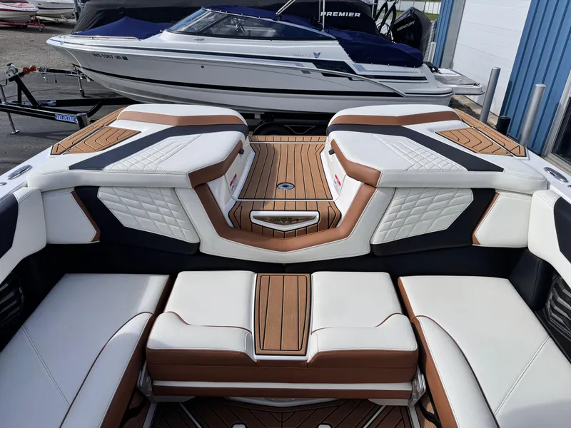 Slide: The Image of 2022 Nautique Super Air Nautique G21 interior with luxurious seating and teak accents. - 10