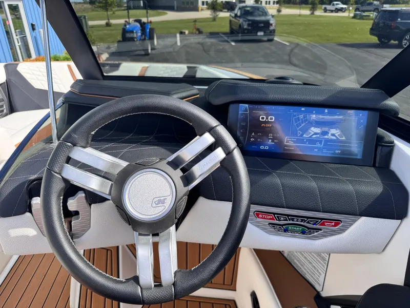 Slide: The Image of 2022 Nautique Super Air Nautique G21 dashboard with steering wheel and digital display. - 12