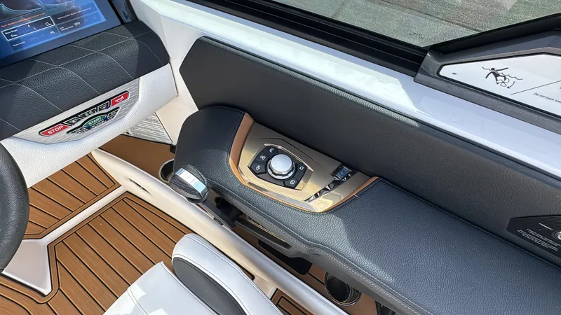 Slide: The Image of 2022 Nautique Super Air Nautique G21 dashboard with control panel and luxurious interior design. - 13
