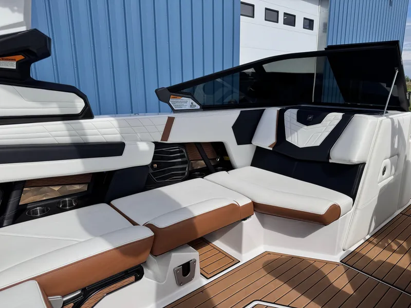Slide: The Image of 2022 Nautique Super Air Nautique G21 interior with white and brown seating. - 16