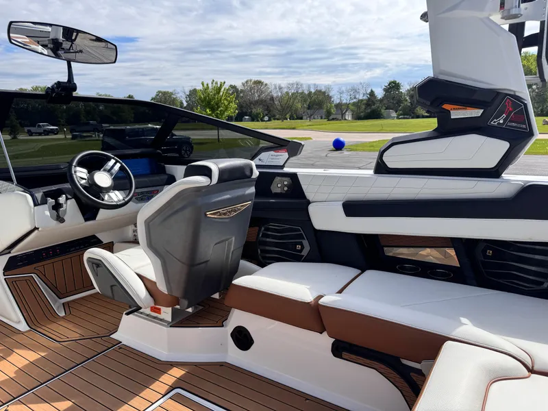 Slide: The Image of Interior of 2022 Nautique Super Air Nautique G21 boat with luxurious seating and modern dashboard. - 17