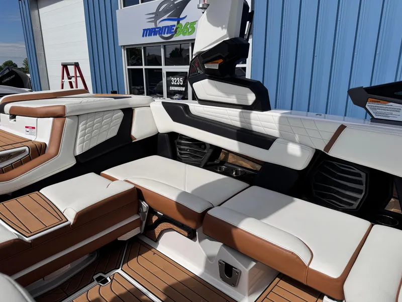Slide: The Image of 2022 Nautique Super Air Nautique G21 interior with white and brown seating, near Marine 365 building. - 19