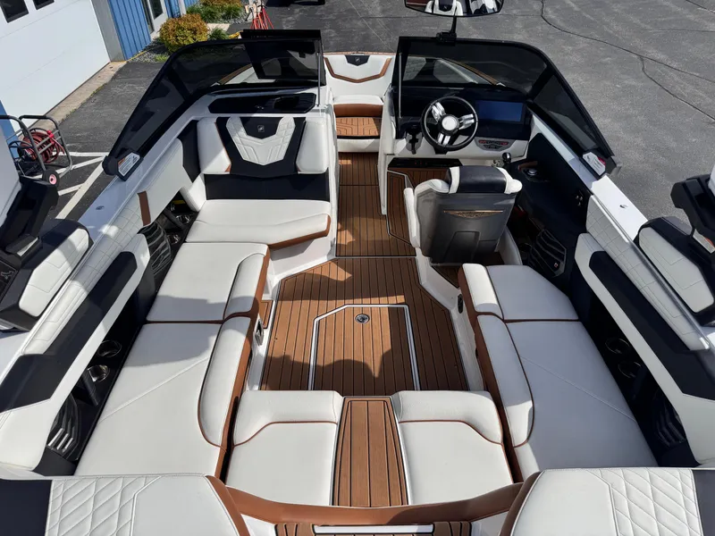 Slide: The Image of 2022 Nautique Super Air Nautique G21 interior with luxurious seating and modern dashboard. - 24