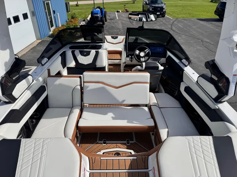 Slide: The Image of 2022 Nautique Super Air Nautique G21 interior with luxurious seating and modern dashboard. - 25