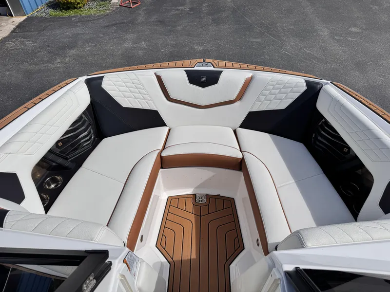 Slide: The Image of 2022 Nautique Super Air Nautique G21 boat interior with white and brown seating. - 27