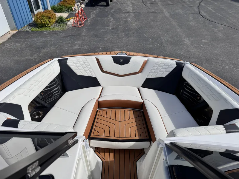 Slide: The Image of 2022 Nautique Super Air Nautique G21 boat interior with luxurious seating and teak flooring. - 6