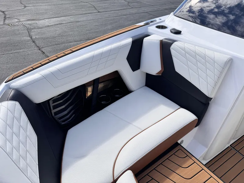 Slide: The Image of Luxurious seating on 2022 Nautique Super Air Nautique G21 boat, featuring elegant white upholstery. - 8