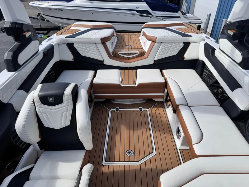 Slide: The Image of Interior of 2022 Nautique Super Air Nautique G21 boat with luxurious seating and teak flooring. - 9
