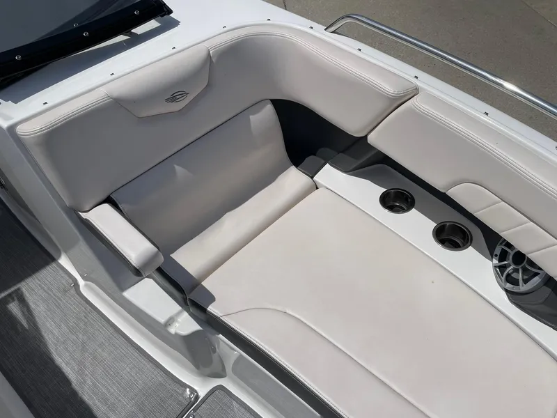 Slide: The Image of 2017 Chaparral 307 SSX boat interior with white leather seating and cup holders. - 12