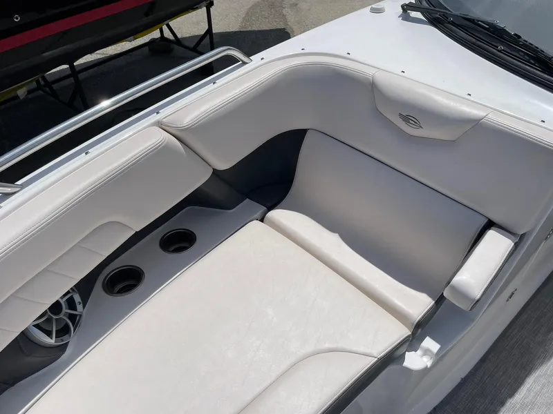Slide: The Image of 2017 Chaparral 307 SSX boat interior with white seating and cup holders. - 13