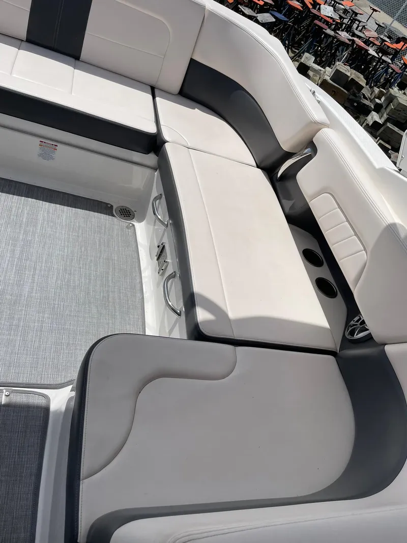 Slide: The Image of 2017 Chaparral 307 SSX boat interior with gray and white seating and cup holders. - 19