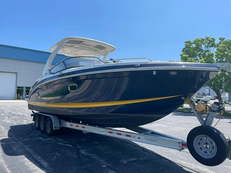 Slide: The Image of 2017 Chaparral 307 SSX boat on trailer, parked outdoors under clear blue sky. - 2