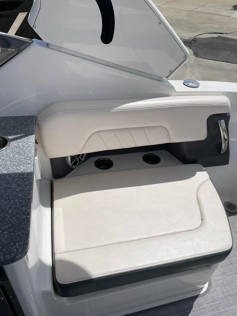 Slide: The Image of 2017 Chaparral 307 SSX boat seat with white upholstery and cup holders. - 20