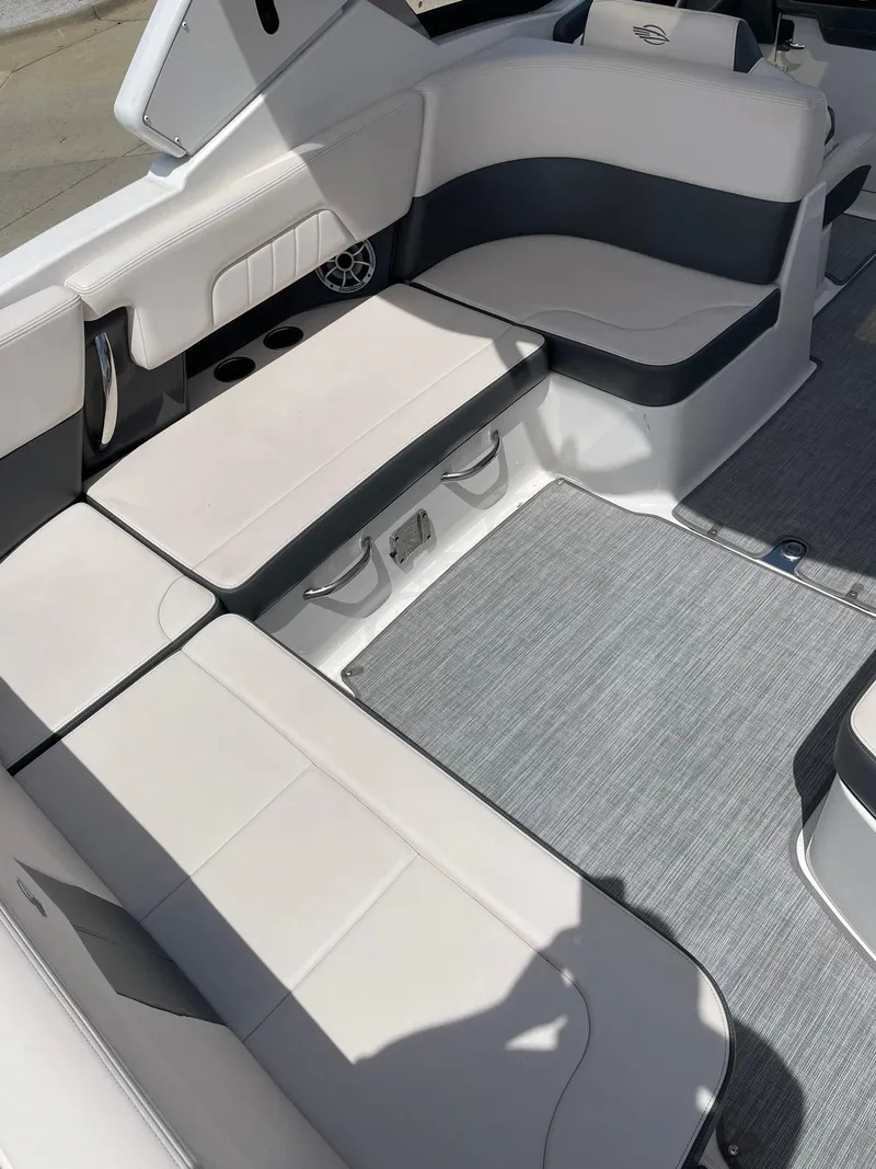 Slide: The Image of 2017 Chaparral 307 SSX boat interior with white and gray seating and flooring. - 23