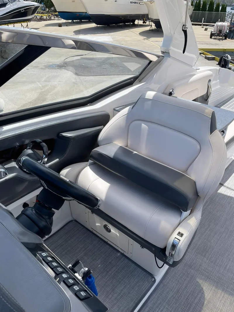 Slide: The Image of 2017 Chaparral 307 SSX boat cockpit with sleek white seating and modern controls. - 6