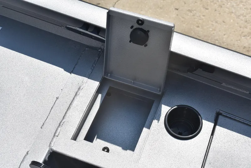 Slide: The Image of Lowe Outlet 20 boat interior detail, 2025 model, featuring storage compartment and cup holder. - 11