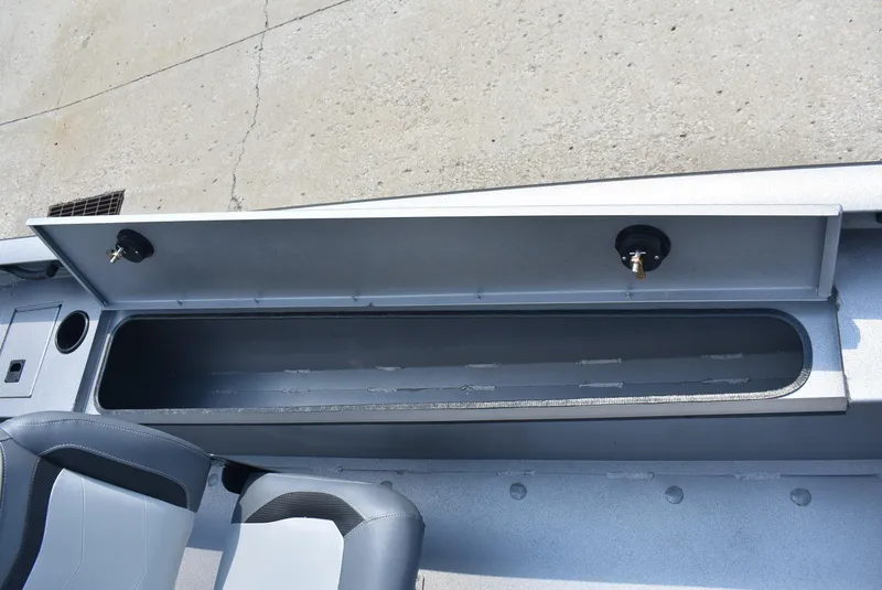 Slide: The Image of 2025 Lowe Outlet 20 boat storage compartment with open lid, showcasing interior space. - 12