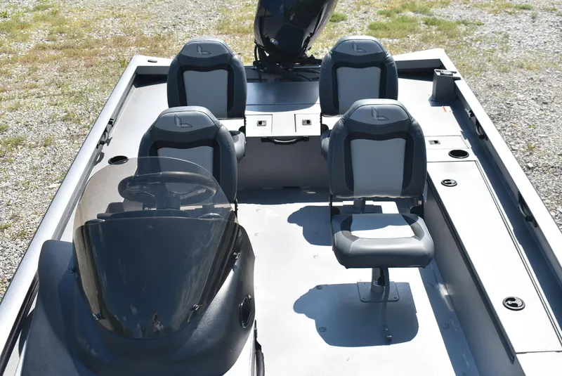 Slide: The Image of 2025 Lowe Outlet 20 boat interior with four seats and steering console. - 9
