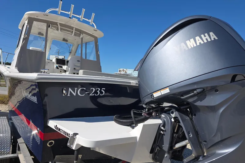 Slide: The Image of 2024 NorthCoast 235 HT boat with Yamaha outboard motor, displayed outdoors. - 17