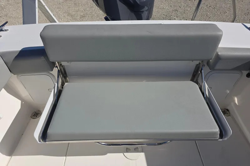 Slide: The Image of 2024 NorthCoast 235 HT boat with foldable gray seat in cockpit area. - 21