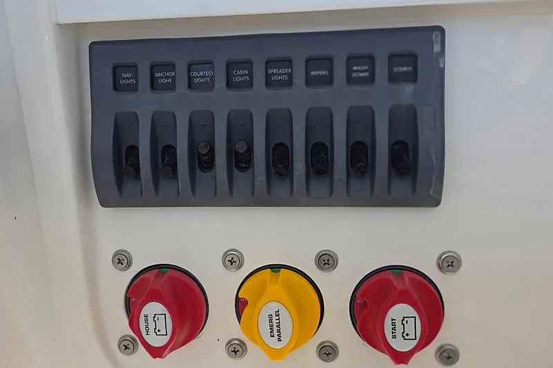 Slide: The Image of Control panel of 2024 NorthCoast 235 HT boat with labeled switches and dials. - 22