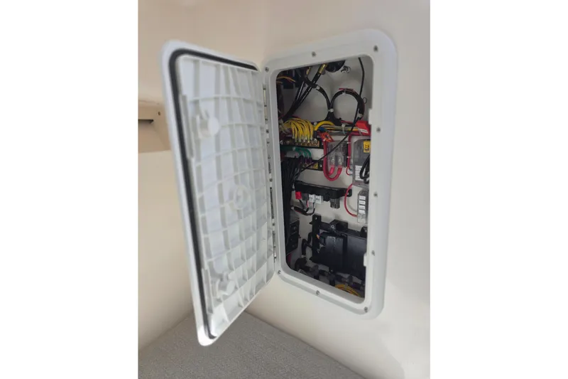 Slide: The Image of Electrical panel inside 2024 NorthCoast 235 HT boat, showcasing wiring and components. - 27