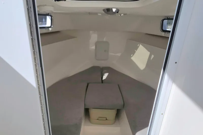 Slide: The Image of 2024 NorthCoast 235 HT cabin interior with cushioned seating and storage. - 29