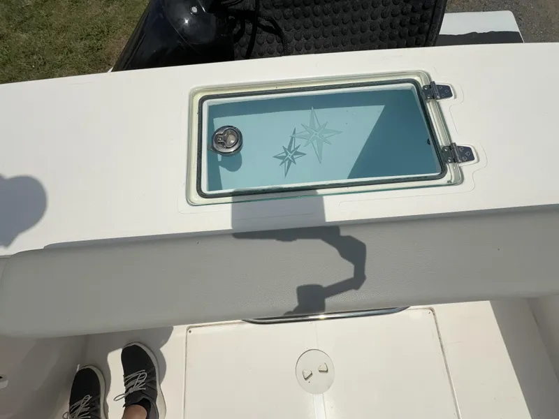 Slide: The Image of 2024 NorthCoast 235 HT boat deck with storage compartment and star design. - 3