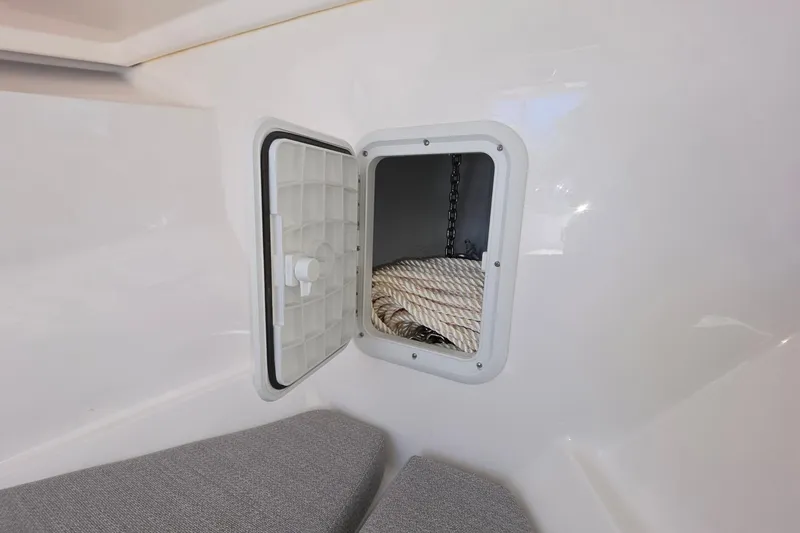 Slide: The Image of 2024 NorthCoast 235 HT boat storage compartment with rope and chain. - 31