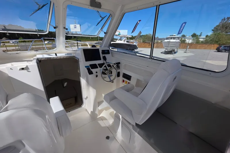Slide: The Image of Interior of 2024 NorthCoast 235 HT boat with steering wheel and seating. - 35