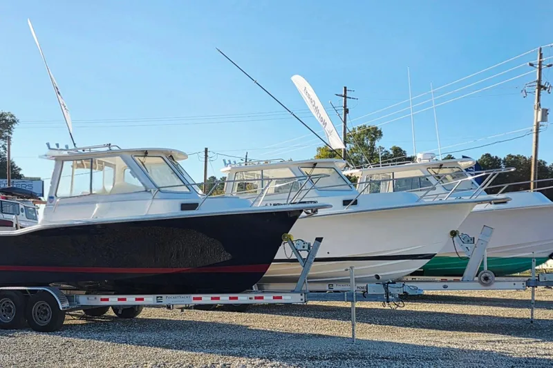 Slide: The Image of 2024 NorthCoast 235 HT boats on trailers in a dealership lot. - 37