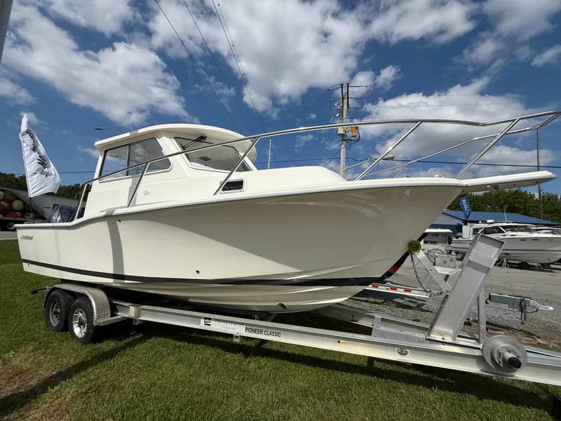 The Image of 2025 NorthCoast 255 HT boat on trailer under clear blue sky. - 0