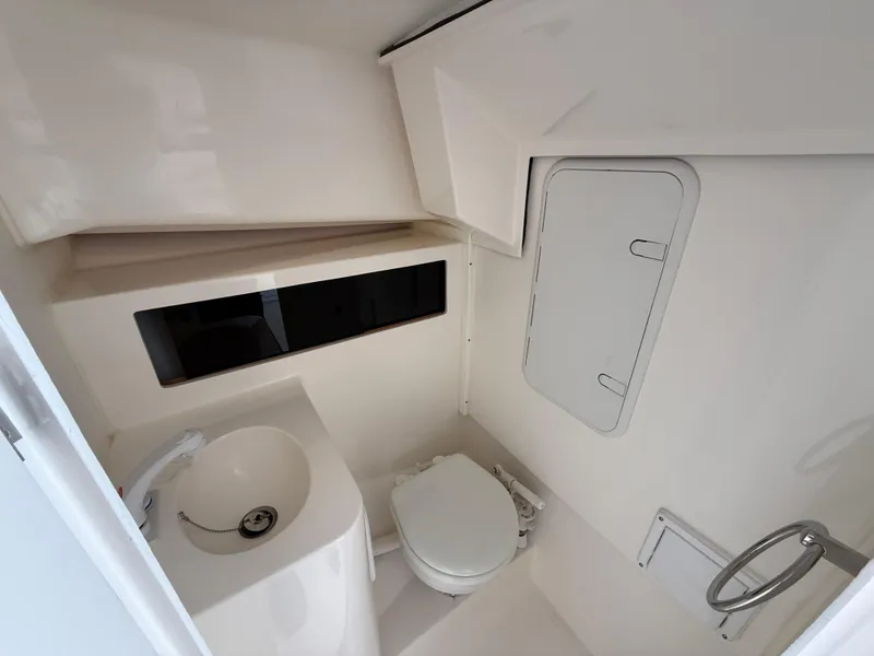 Slide: The Image of 2025 NorthCoast 255 HT cabin interior with blue bedding and overhead hatch. - 11