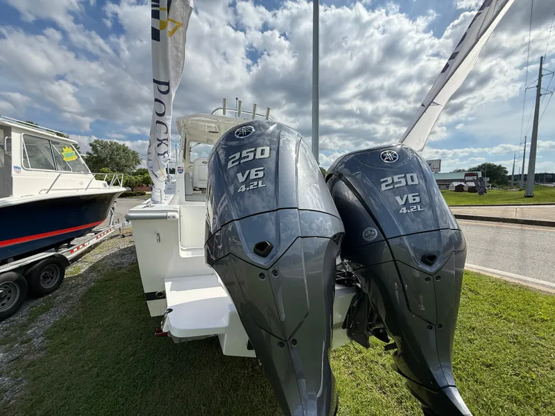 Slide: The Image of 2025 NorthCoast 255 HT boat on trailer under blue sky with clouds. - 2