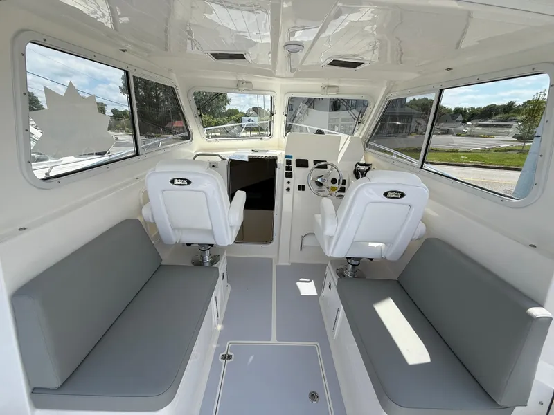 Slide: The Image of 2025 NorthCoast 255 HT boat with dual 250 V6 4.2L engines displayed outdoors. - 4
