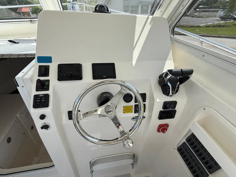 Slide: The Image of Interior of 2025 NorthCoast 255 HT boat with helm and seating area. - 7