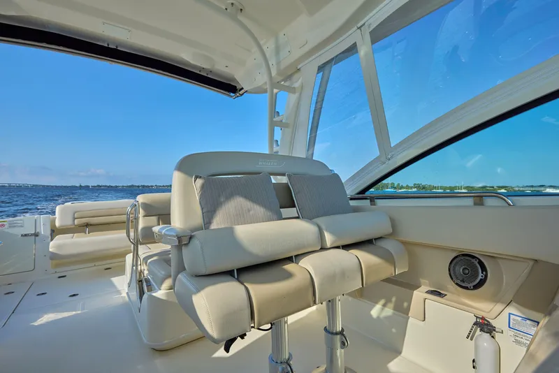 Slide: The Image of Interior of 2016 Boston Whaler 320 Vantage boat with cushioned seating and ocean view. - 10