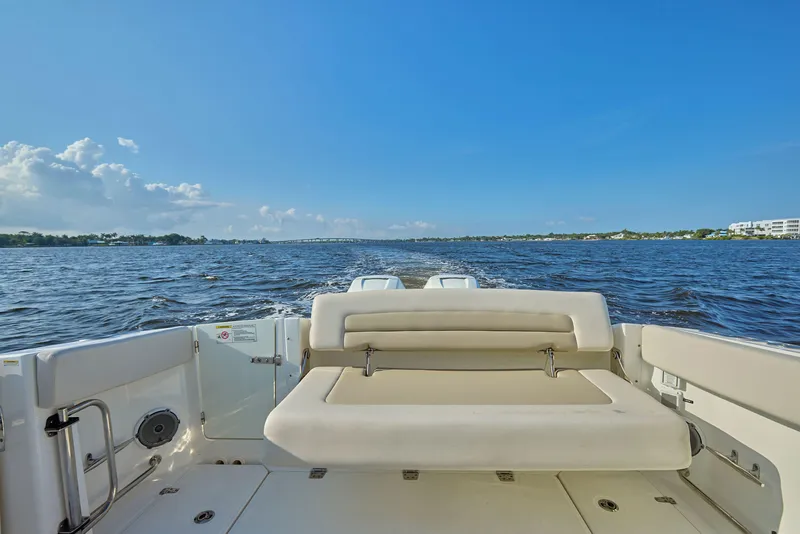 Slide: The Image of 2016 Boston Whaler 320 Vantage boat interior with seating, on a sunny day at sea. - 12